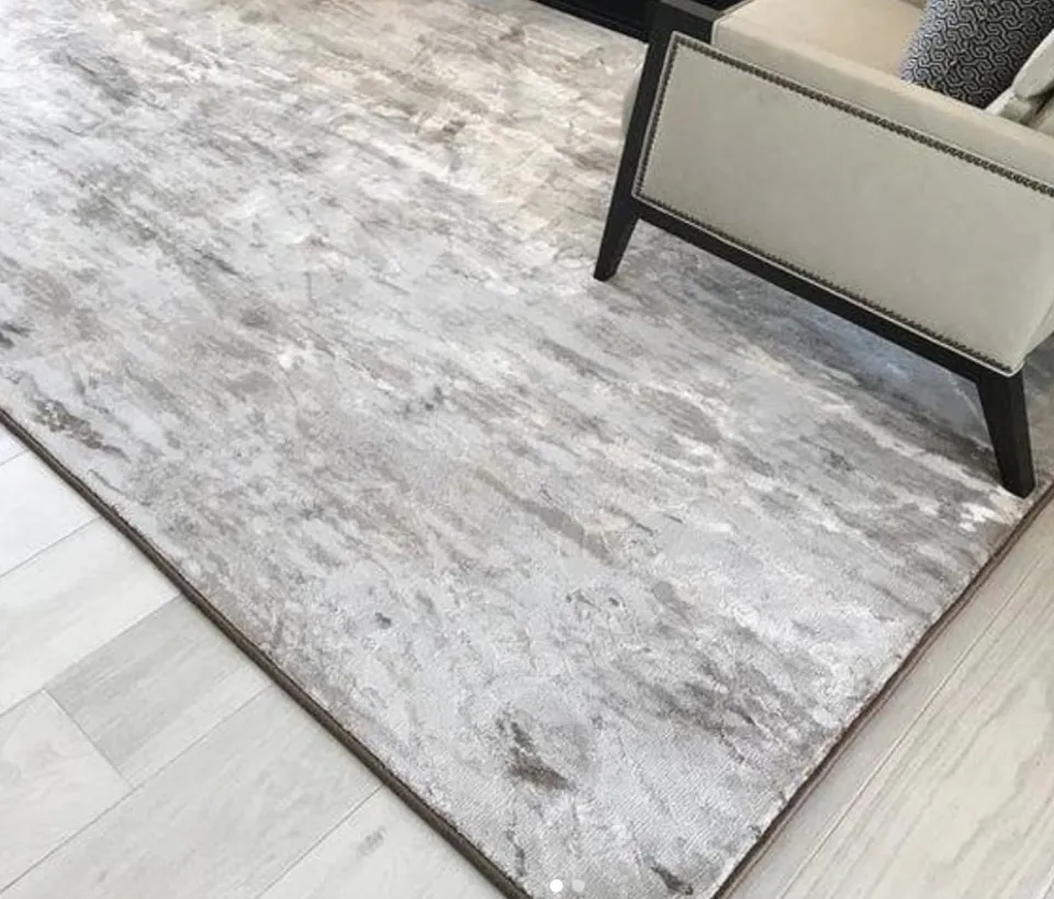 A custom-cut area rug with bound edges in a living room